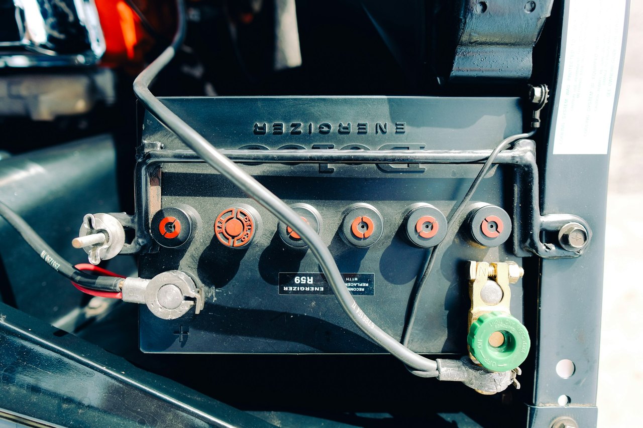 A car battery with cables clamped to its terminals, the part that decides whether a car will not start on a cold morning in Hanford, California