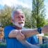 Senior man stretching arm outside for shoulder pain relief