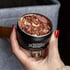 Dr. Killigan's black cedar chip canisters on a wooden surface with cedar chips and folded sweaters