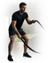 Mann in schwarzer Sportkleidung trainiert mit Battleropes in einem Fitnessstudio mit grünem Licht.