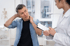 A patient discusses neck pain symptoms with a doctor.