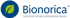 Bionorica Logo mit grünem Blatt im blauen Kreis und dem Slogan Decoding nature. Empowering health.