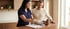 A healthcare professional in blue scrubs organizes medication bottles and a pill organizer for a male patient.