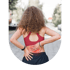 A woman in a red sports bra holds her lower back, which is highlighted with a red glow indicating pain or injury.