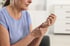 A woman experiencing wrist pain because of osteoarthritis.