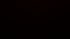 Dark background with a subtle, red-lit grid pattern in the upper right corner.