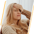 Blonde woman with Chronic Fatigue holding forehead in discomfort
