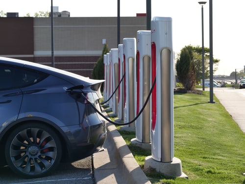 Two electric vehicles charging at home in a Westminster, CA driveway using Level 2 chargers