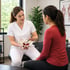 Medical clinic therapist explains pelvic model to patient