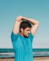 Man stretching on beach representing men’s health and wellness support