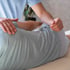 A physical therapist performing sciatica pain treatment on a patient.