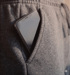Smartphone in the pocket of grey sweatpants.