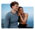 Smiling couple embracing by the ocean, reflecting natural wellness and balance