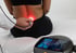 Doctor using red light laser therapy on a patient's lower back.