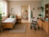 Wohnzimmer mit Pflegebett und Hilfsmitteln