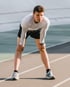 Runner resting on track due to bone-on-bone joint pain discomfort