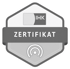 Graues, sechseckiges IHK-Zertifikat mit weißem Text "ZERTIFIKAT" und einem WLAN-Symbol.