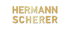 Goldener Schriftzug Hermann Scherer in serifenlosen Großbuchstaben auf schwarzem Hintergrund.