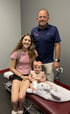 Family in a medical clinic during pediatric care consultation