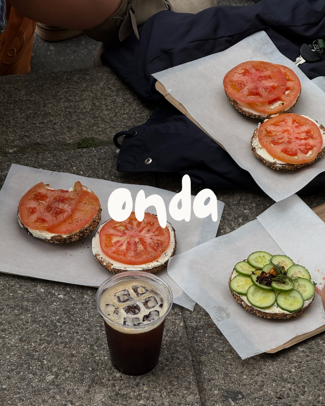 Bagels with tomato and cucumber and an iced coffee