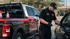 Towing Corona technician performing a car lockout service to safely unlock a customer's vehicle without damage.