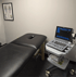Medical exam room with a black treatment table at Midwest Pain Relief Center, LLC.