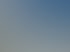 Moderne weiße Wohngebäude mit geschwungenen Balkonen und geraden Linien unter blauem Himmel.