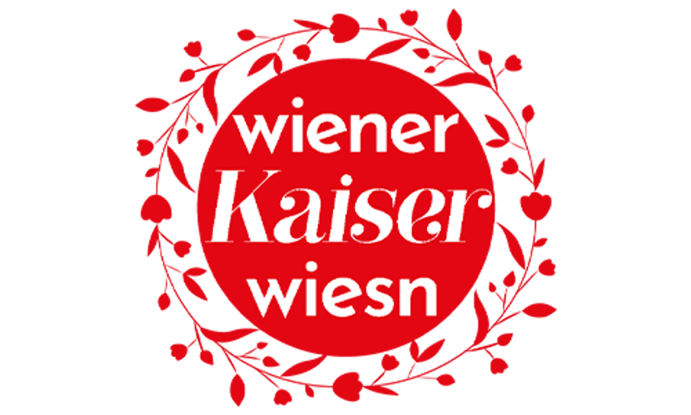 Logo der Wiener Kaiser Wiesn mit weißem Text in einem roten Kreis, umrahmt von einem roten Blumenkranz auf schwarzem Grund.
