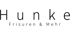Hunke Friseure & Mehr Logo, schwarzer Text auf dunkelgrünem Hintergrund.