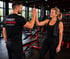 Ein Trainer von Finest Fitness Lindenberg und eine Frau geben sich im Fitnessstudio ein High Five.