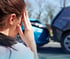 Woman with a headache after being in a car accident.