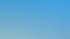 Ein Außenpool mit blauen Fliesen und Palmen unter klarem blauem Himmel.