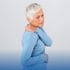 Older woman holding and rubbing shoulder in pain