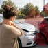 Woman holds her neck in pain after a car accident.