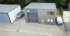 Gebäude von Sachmann Elektrotechnik mit Boot, Anhänger und Lieferwagen vor grünen Bäumen.