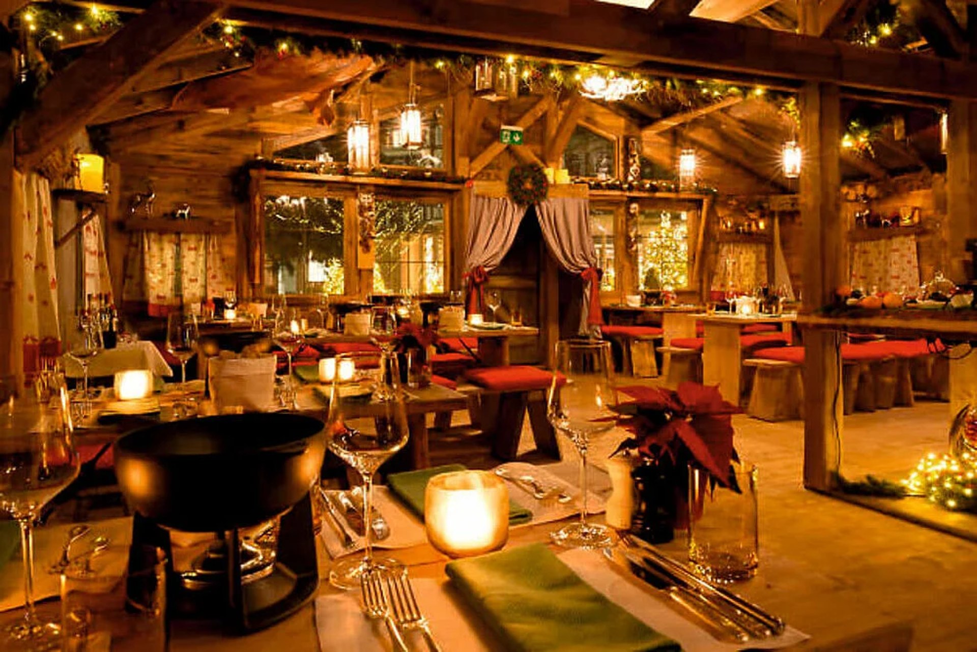 Festlich gedeckte Tafel im Chalet mit Fonduetopf und Laternen