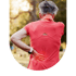 Senior woman in red athletic wear holding her lower back with a red glow indicating pain.
