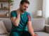 Man experiencing neck and arm pain from a pinched nerve condition