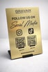 Goldfarbenes Schild mit "GRAVAIX", "FOLLOW US ON Social Media", Instagram-, TikTok-Logos und zwei QR-Codes.