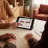 A person points to a business chart with data visualizations on a tablet screen during a meeting at a desk.
