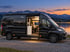 Adria Twin Edition 640 SGX in Schwarz am See zur blauen Stunde mit offener Schiebetür