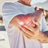 Man holds painful elbow, highlighting anti-inflammatory laser therapy.