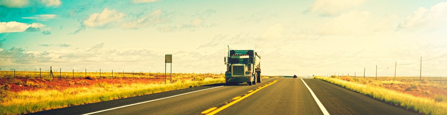 Class 1 driving instructor and student beside a semi truck at a Cameron Driver Education training yard in Edmonton, Alberta