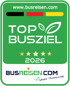 Grünes Siegel mit „TOP BUSZIEL 2025“, fünf goldenen Sternen, "www.busreisen.com" und "Green Travelling!" Text.