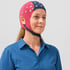 A woman smiles while wearing a brain mapping cap.