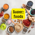 Superfoods: Verschiedene Superfoods wie Beeren, Nüsse, Samen, Pulver und Gewürze auf hellem Hintergrund.