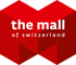 Rotes Logo mit "the mall" und "of switzerland" in Weiß auf polygonalem Hintergrund.