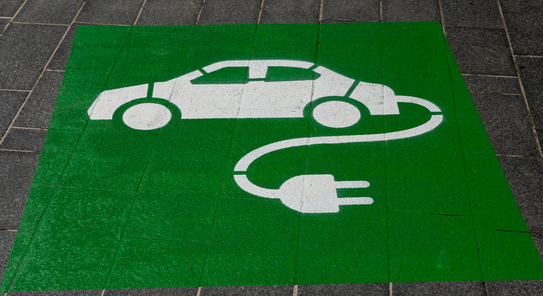 A marked EV charging bay with charging-station signage