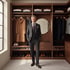 Elegant wardrobe with suits, wool coats and folded sweaters