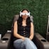 Woman using BrainTap therapy headset for relaxation and mental wellness